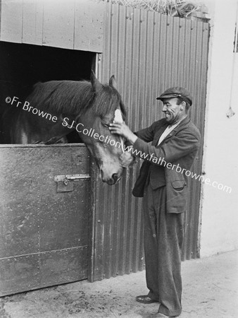 GENT WITH RACEHORSE AT STABLE